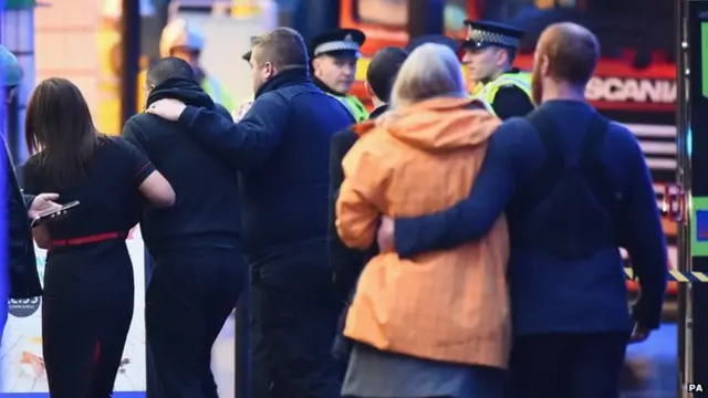 Members of the public console each other after George Square incident