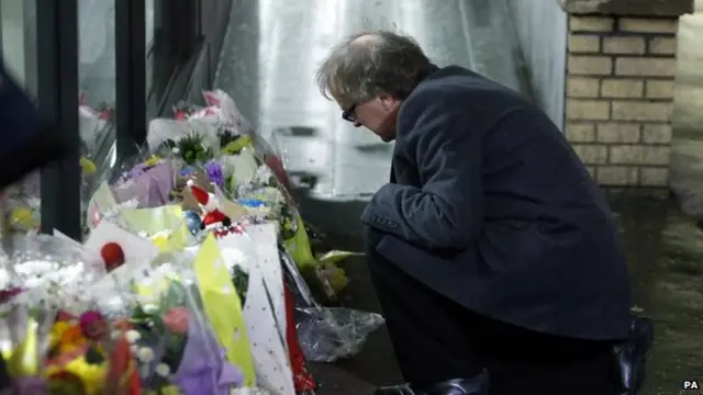 The Bishop of Glasgow and Galloway, the Very Rev Dr Gregor Duncan lays flowers laid at the scene in George Square,