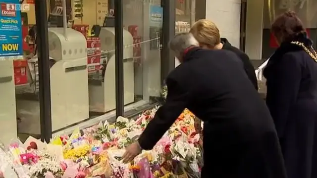 First Minister Nicola Sturgeon and council leaders examine floral tributes