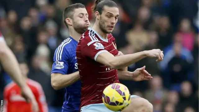 Andy Carroll challenges Gary Cahill for the ball