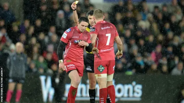 Kristian Phillips of Scarlets is shown a yellow card