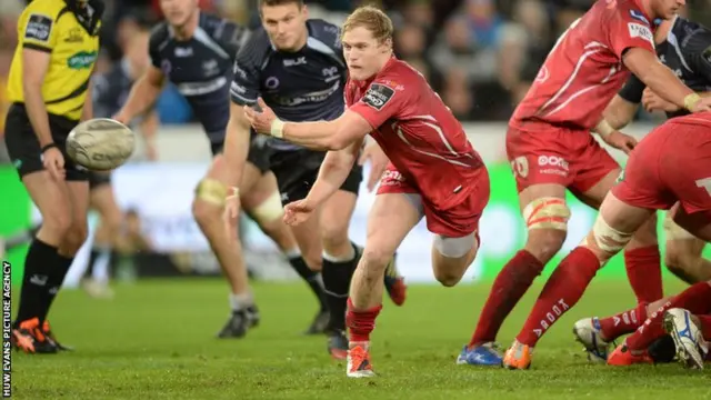 Aled Davies of Scarlets gets the ball away