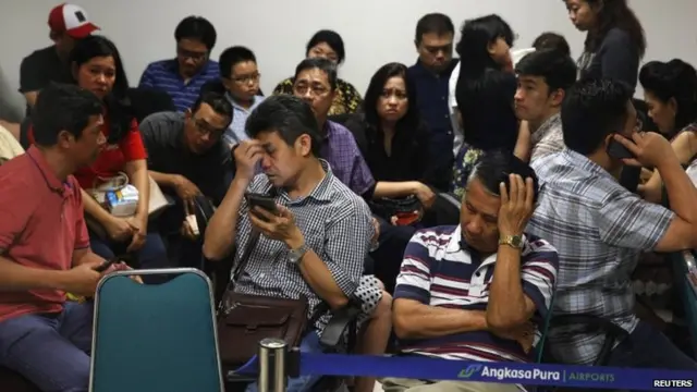 Family members of passengers onboard AirAsia flight QZ8501 react at a waiting area in Juanda International Airport, Surabaya on 28 December 2014.