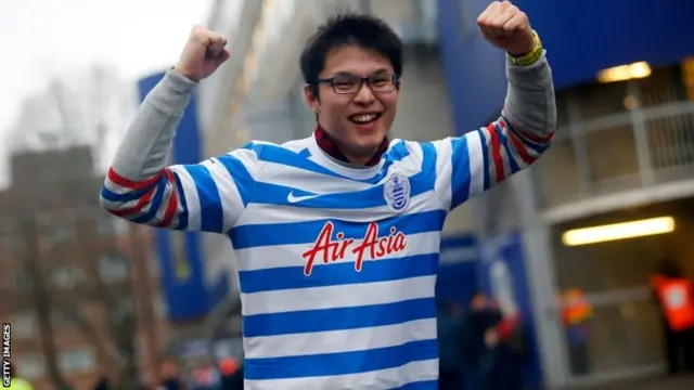 A QPR fan outside the ground pre-match