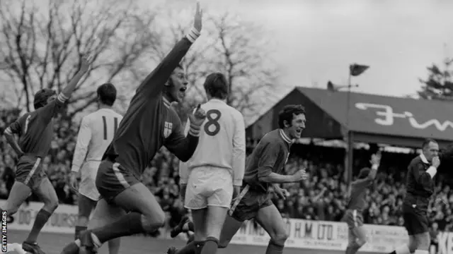 Colchester United's Ray Crawford raising his arm in jubilation after scoring his team's first goal against Leeds United in the fifth round of the FA Cup at Layer Road in 1971.