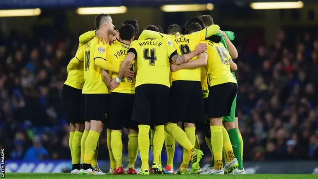 Watford players huddle before the game