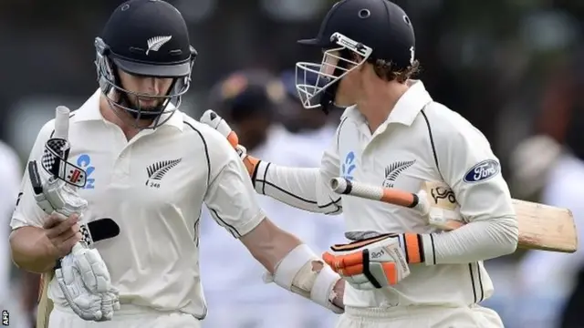 New Zealand's Kane Williamson and BJ Watling leave the field after day three