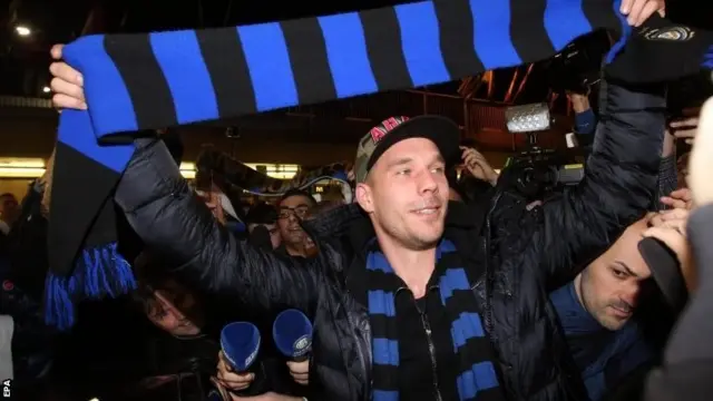 Arsenal striker Lukas Podolski embraces his loan move to Inter