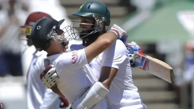 South Africa batsmen Dean Elgar and Hashim Amla celebrate their win over West Indies