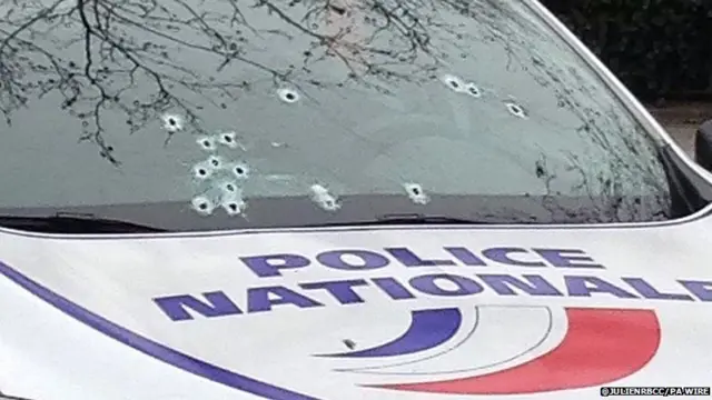 Bullet holes in a police car