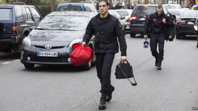 Firemen at the scene of the attack on the Charlie Hebdo offices