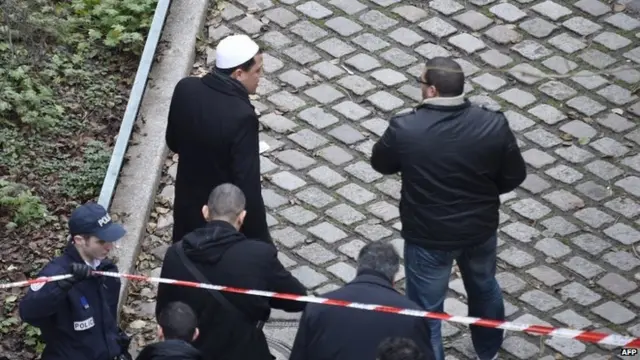 Hassen Chalghoumi (L, white skull cap), Imam of Drancy"s mosque, arrives at the headquarters of the French satirical newspaper Charlie Hebdo in Paris on January 7, 2015