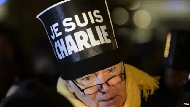 A man adorns his hat with a placard with "Je suis Charlie" (I"am Charlie), written on it, during a rally in solidarity with the killed Charlie Hebdo employees, in Lausanne, Switzerland, 07 January 2015