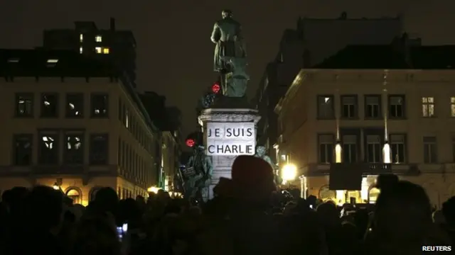 A placard which reads "I am Charlie" is pictured as people gather to pay tribute to the victims of a shooting by gunmen at the offices of weekly satirical magazine Charlie Hebdo in Paris, in front of the European Parliament in Brussels January 7, 2015