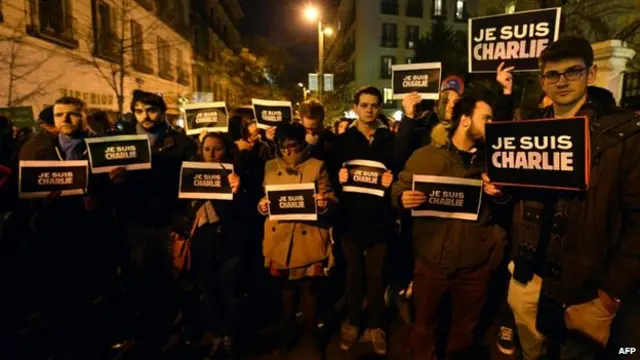 People hold placards reading "I am Charlie" during a gathering in support of the victims of the terrorist attack on French satyrical newspaper Charlie Hebdo, in front of French Embassy in Madrid, on January 7, 2015