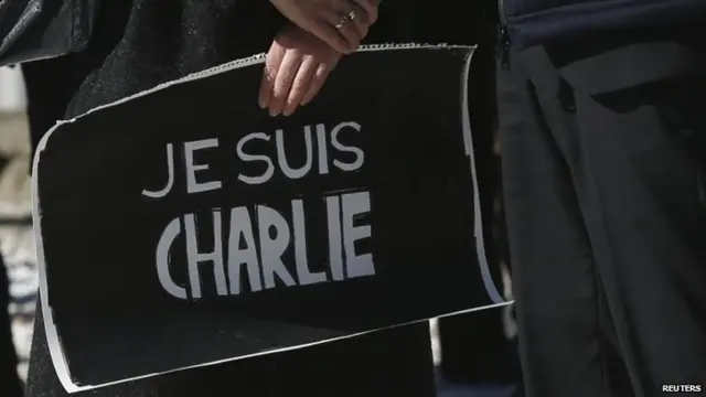 A protestor carries a sign reading "I am Charlie" in French