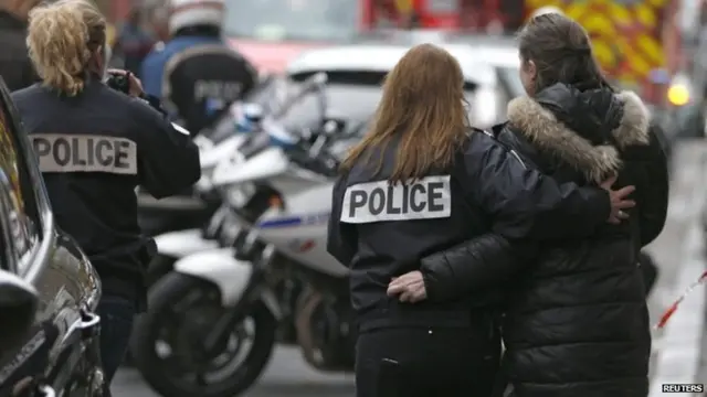 French police assist a woman after a shooting in the street of Montrouge near Paris January 8, 2015