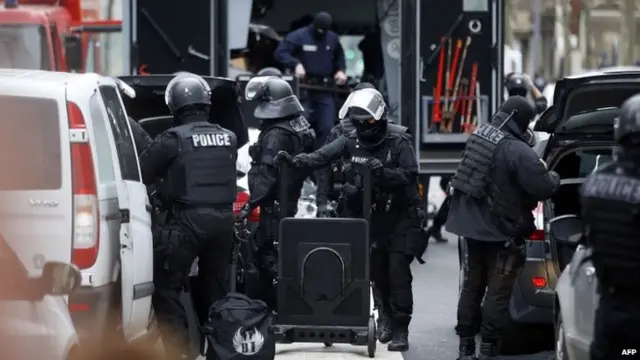 Members of the French national police intervention group (BRI) prepare their gear near the site of a shooting on the morning of January 8, 2015 in Montrouge, south of Paris