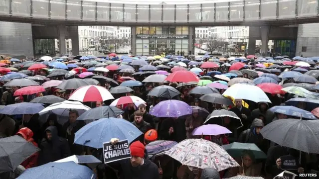 A man holds a placard that reads "I am Charlie", as members of the European Parliament and citizens gather during a minute of silence for victims of the shooting at the Paris offices of weekly newspaper