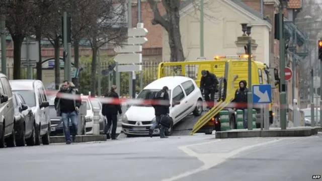 Police tow away the car believed to have been used by the attacker who shot dead a French police woman