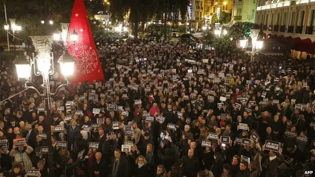 People hold signs reading 'I am Charlie' during a rally in Monaco on January 8, 2015, a day after a deadly attack on the Paris headquarters of French satirical weekly Charlie Hebdo.