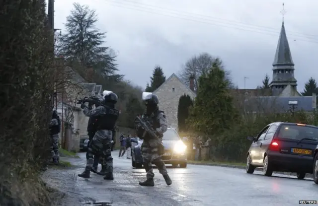 Members of the French GIPN intervention police forces secure a neighbourhood in Corcy, northeast of Paris January 8, 2015