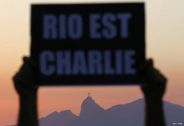 A demonstrator holds a placard in tribute to the victims of a shooting by gunmen at the offices of weekly satirical magazine Charlie Hebdo in Paris, during a demonstration organized by the NGO Rio de Paz (RIo of Peace) in Niteroi, near Rio de Janeiro, January 8, 2015