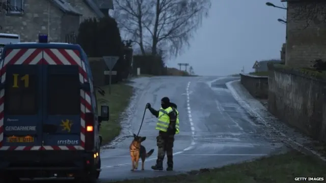 A policeman with a sniffer dog