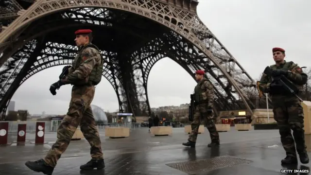 Armed security guards patrol around the Eiffel Tower. Photo: 9 January 2015