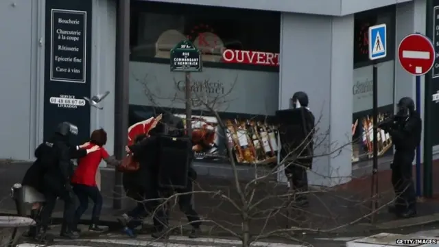 People are led away from the scene as Police mobilize with reports of a hostage situation at Port de Vincennes on 9 January 2015 in Paris, France