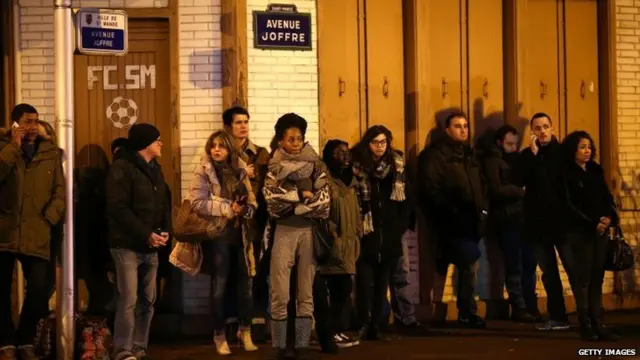 People watch on Avenue Joffre as police mobilize at the hostage situation at Port de Vincennes on 9 January 2015 in Paris, France.