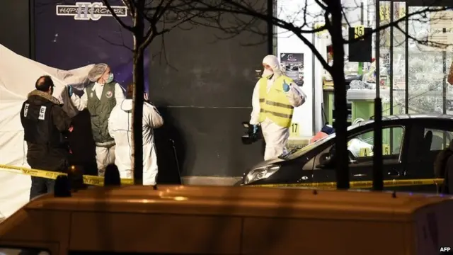 French police officers and forensic experts investigate the scene at the Hyper Casher kosher grocery store near Porte de Vincennes in eastern Paris on January 9, 2015