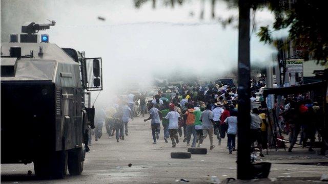 Armoured vehicle and protestors in Haitian capital Port-au-Prince