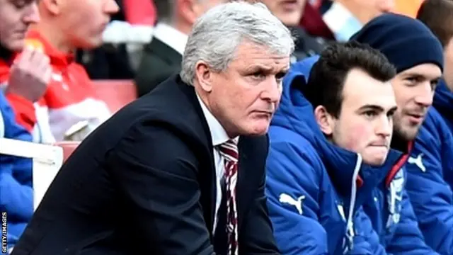 Mark Hughes looks on