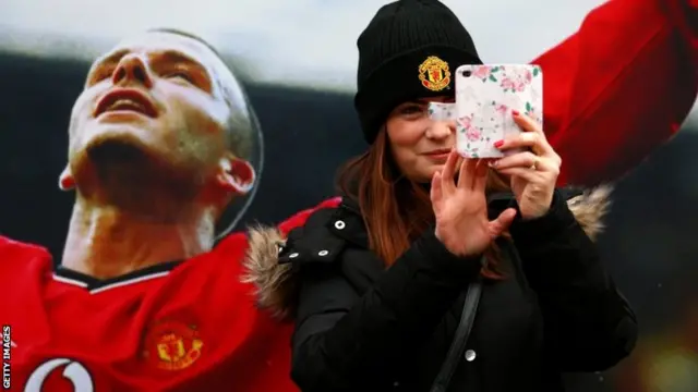 A Manchester United fan takes a selfie