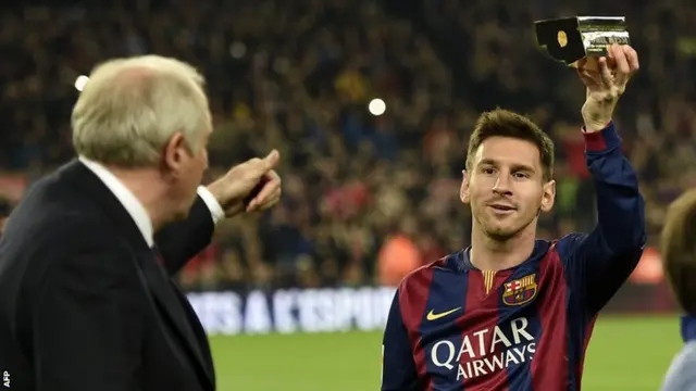 Barcelona striker Lionel Messi receives an award