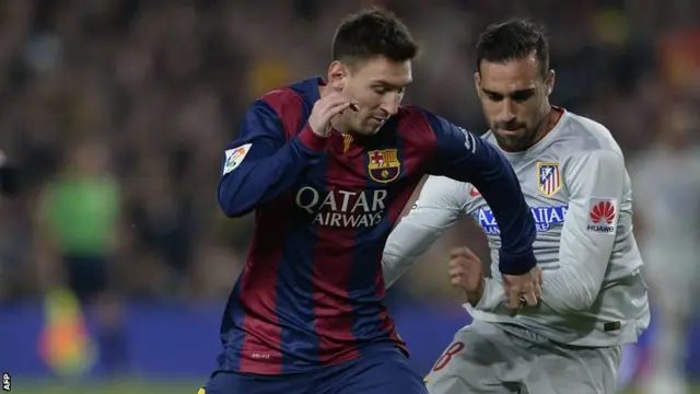 Barcelona striker Lionel Messi takes on Atletico's Jesus Gamez