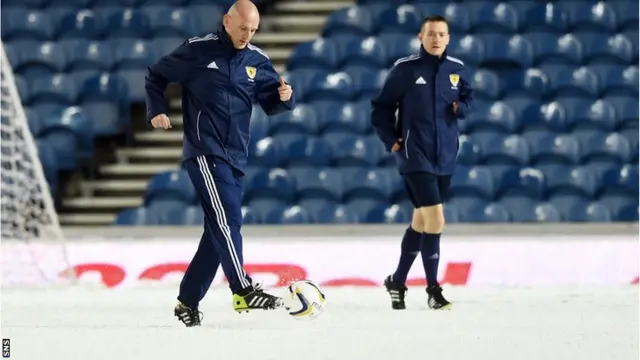 Referee Bobby Madden tests the pitch ahead of kick-off