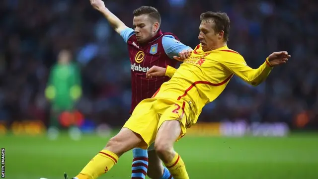 Tom Cleverley and Lucas battle for the ball