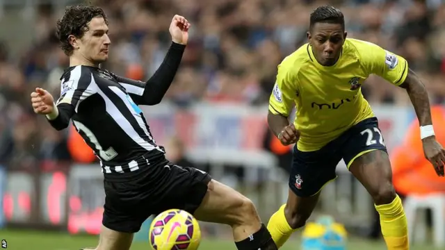 Daryl Janmaat challenges for the ball