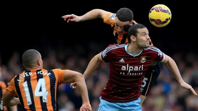 Hull's James Chester beats West Ham striker Andy Carroll to the ball