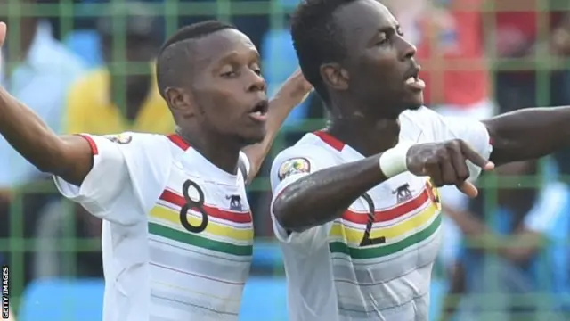 Guinea's Ibrahim Traore and Mohamed Lamine Traore celebrate