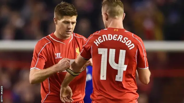 Steven Gerrard passes the captain's armband to Jordan Henderson