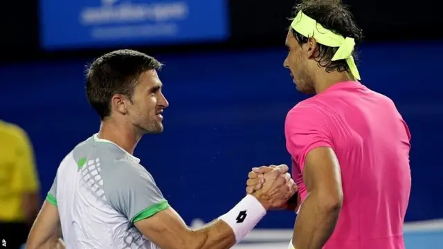 Rafael Nadal of Spain, right, shakes hands with Tim Smyczek