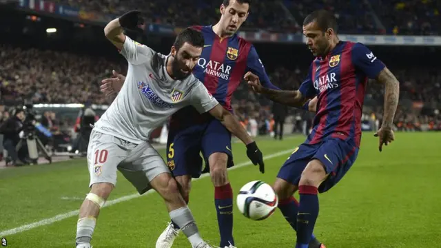 Arda Turan battles for the ball