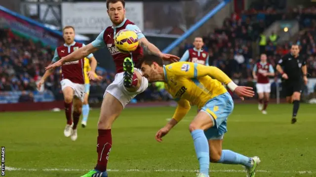 Ashley Barnes challenges for the ball