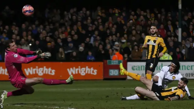 Cambridge United keeper Chris Dunn saves from Radamel Falcao