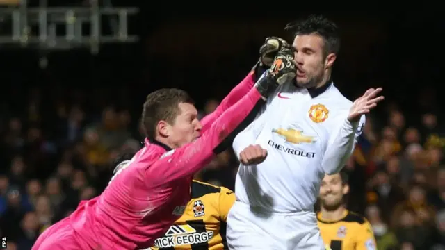 Cambridge United keeper Chris Dunn (left) and Manchester United striker Robin Van Persie