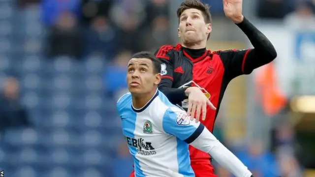 Josh King and Federico Fernandez challenge for the ball