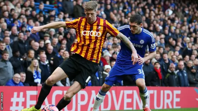 Lewis Clarkson of Bradford City controls the ball under pressure from Andreas Christensen